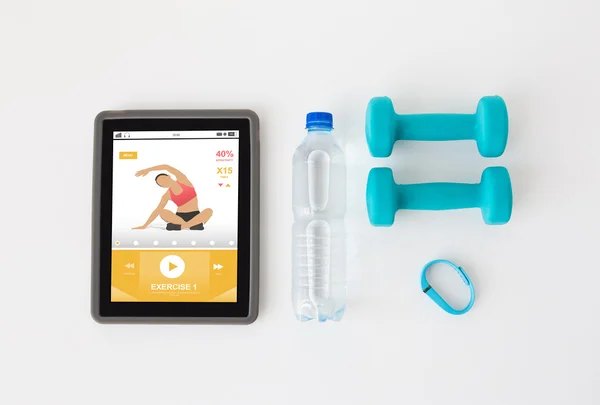 Tablet pc, dumbbells, fitness tracker and bottle — Stock Photo, Image