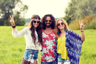 happy young hippie friends showing peace outdoors clipart