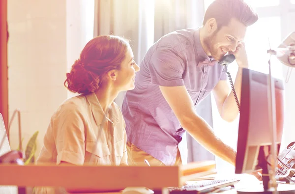 Happy creative team calling on phone in office — Stock Photo, Image