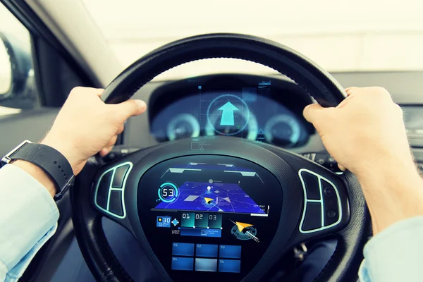 Close up of man driving car with gps navigator — ストック写真