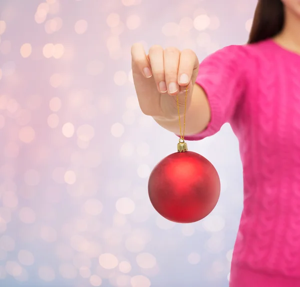 Close up of woman in sweater with christmas ball — Stock Photo, Image