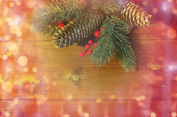 Close up of fir branch with cones on wooden table — Stock Photo, Image