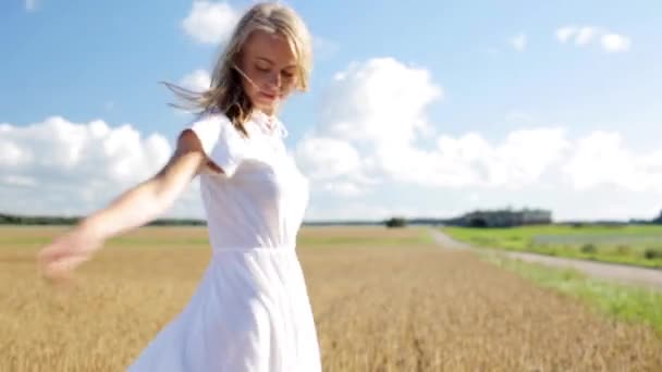 Χαμογελαστή νεαρή γυναίκα με λευκό φόρεμα στον τομέα των δημητριακών — Αρχείο Βίντεο