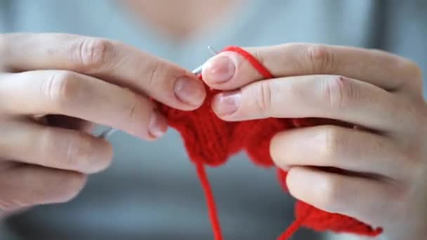 Woman knitting with needles and red yarn — Stock Video