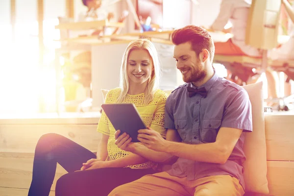 Happy creative team with tablet pc in office — Stock Photo, Image