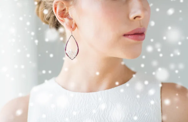 Close up of beautiful woman face with earring — Stock Photo, Image