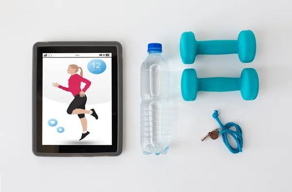 Tablet pc, dumbbells, whistle and water bottle — Stock Photo, Image