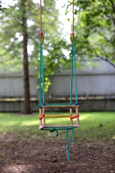 Lege houten schommel opknoping in de zomertuin — Stockfoto