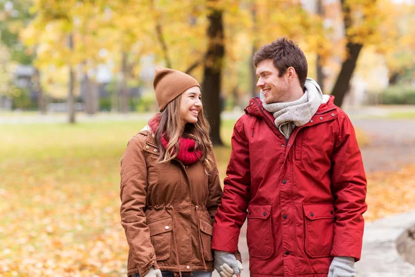 Felice giovane coppia a piedi nel parco autunnale — Foto Stock