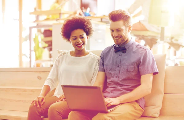 Happy creative team with laptop in office — Stock Photo, Image