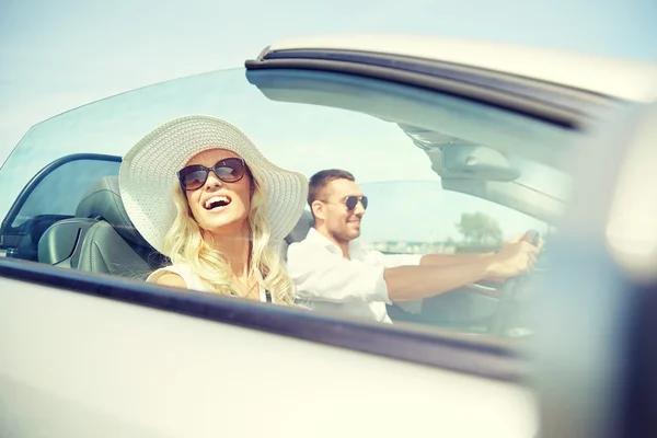 Happy man and woman driving in cabriolet car — Stock Photo, Image