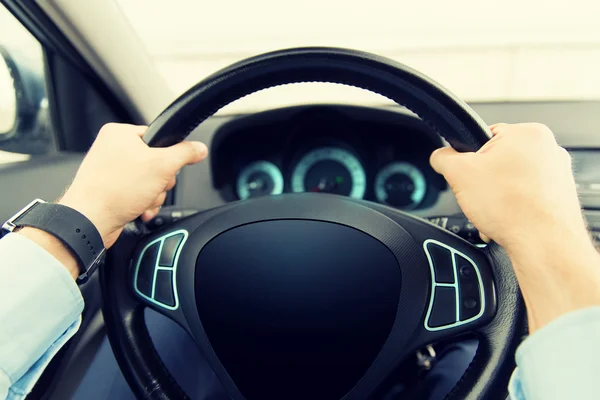 Close up of man driving car with computer screen — Stock Photo, Image