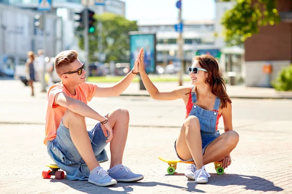 Pareja adolescente con patinetas en la calle de la ciudad — Foto de Stock