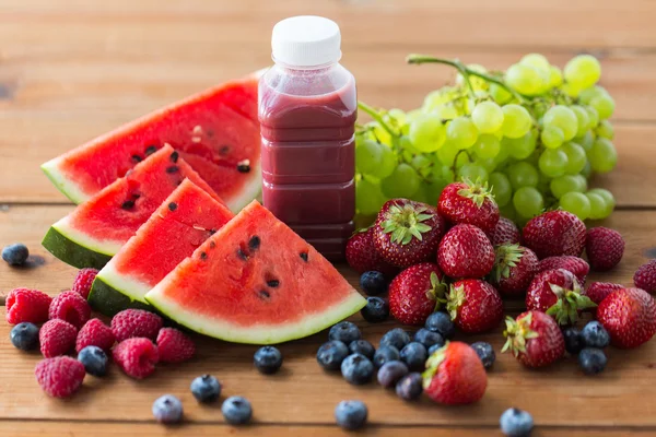 Бутылка с фруктовым и ягодным соком или смузи — стоковое фото