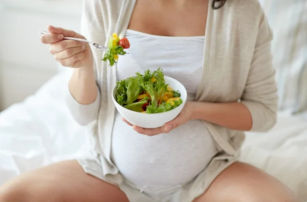 Kobieta w ciąży w domu jedzenie Sałatka z bliska — Zdjęcie stockowe