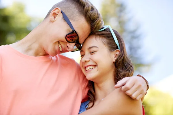 Happy teenage couple hugging at summer — Stock Photo, Image