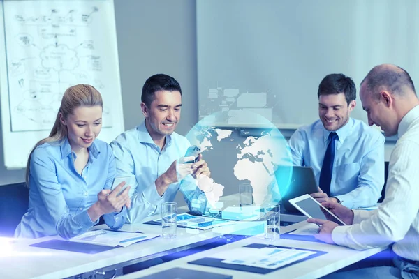 Smiling business people with gadgets in office — Stock Photo, Image