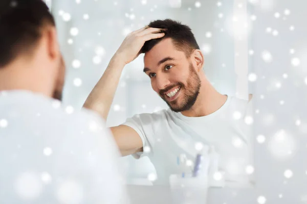 Felice giovane cercando di specchio a casa bagno — Foto Stock