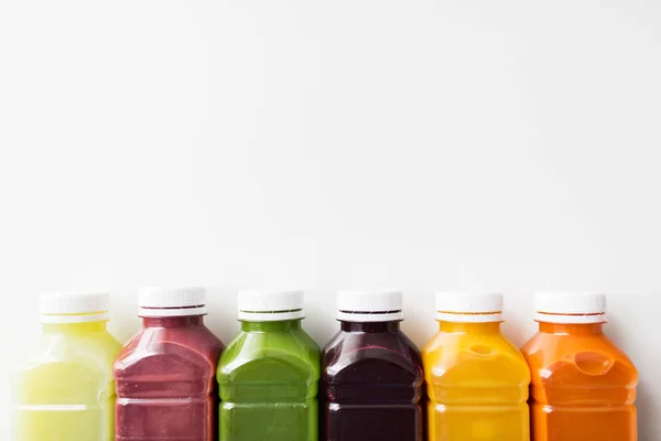 Bottles with different fruit or vegetable juices — Stock Photo, Image