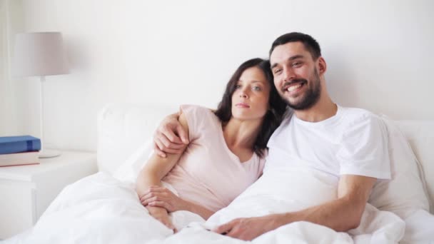 Casal feliz assistindo tv na cama em casa — Vídeo de Stock