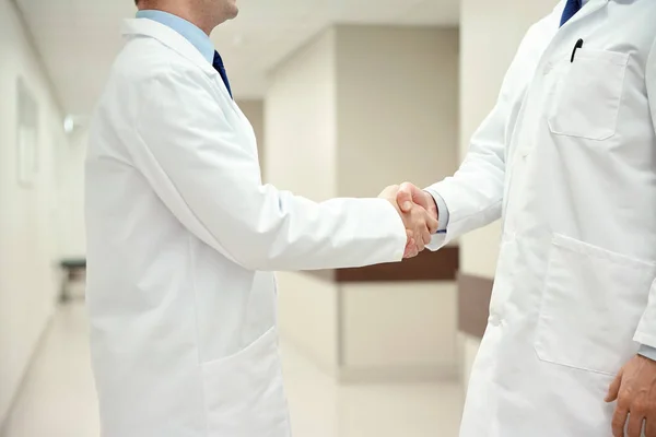 Close up of doctors making handshake — Stock Photo, Image