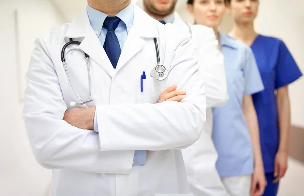 Close up of medics or doctors at hospital corridor — Stock Photo, Image