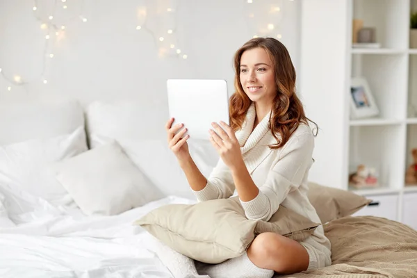 Mutlu genç kadın yatakta evde tablet pc ile — Stok fotoğraf