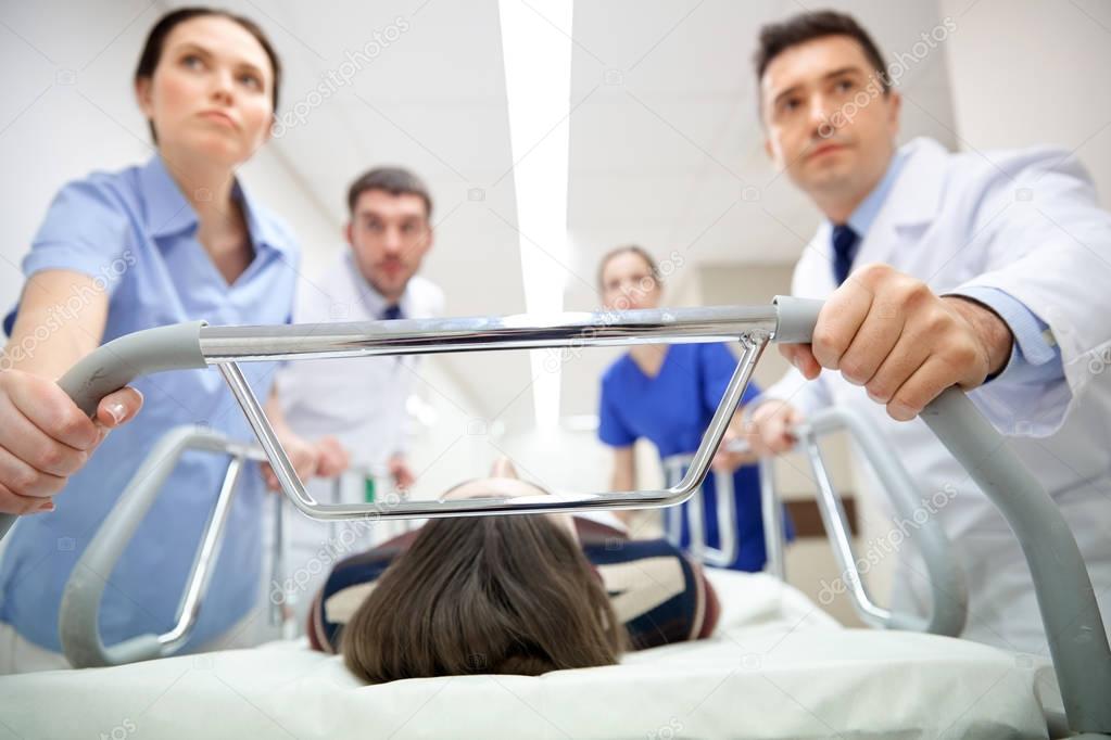 Medics and patient on hospital gurney at emergency — Stock Photo © Syda