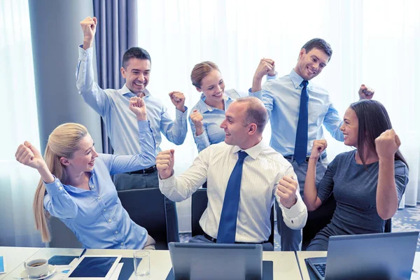 Business people celebrating victory in office — Stock Photo, Image