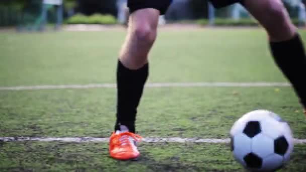 Fotbollspelare som leker med bollen på fältet — Stockvideo