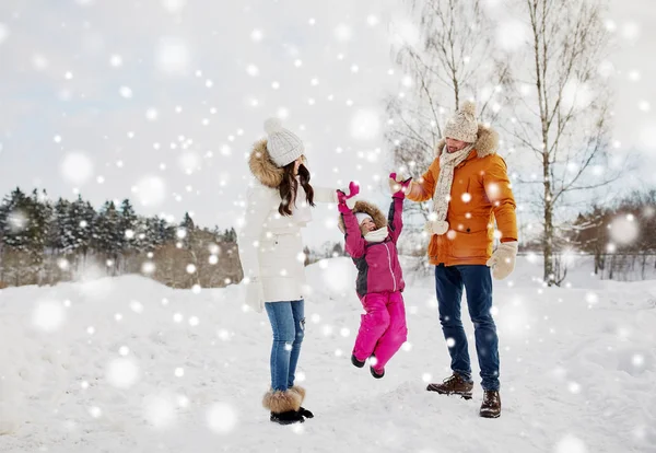 Happy family in winter clothes walking outdoors — Stock Photo, Image