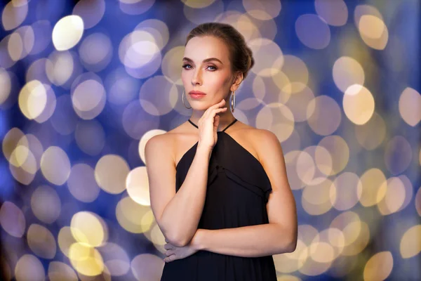 Красивая женщина в черном носит бриллиантовые украшения — стоковое фото