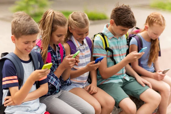 Учнів початкової школи зі смартфонами — стокове фото