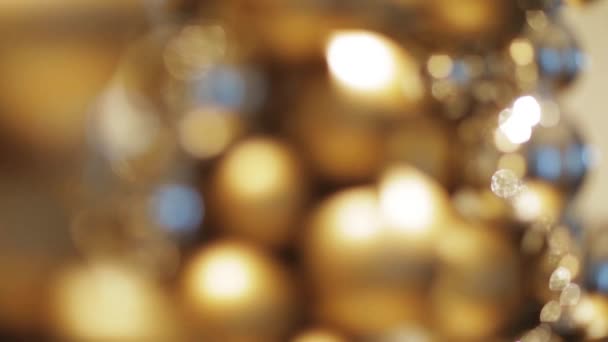 Golden christmas decoration or garland of beads — Stock Video