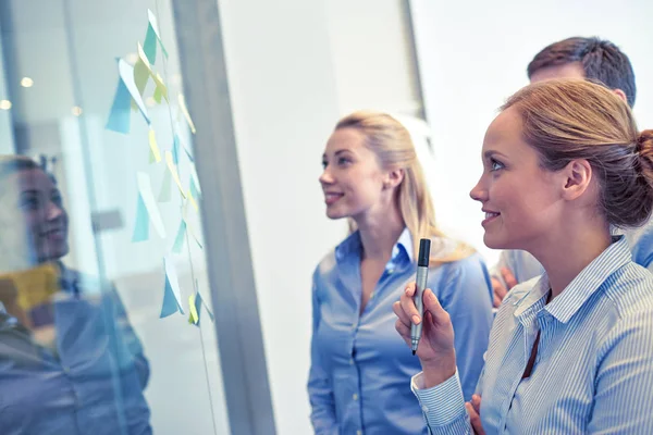 Smiling business people with marker and stickers — Stock Photo, Image