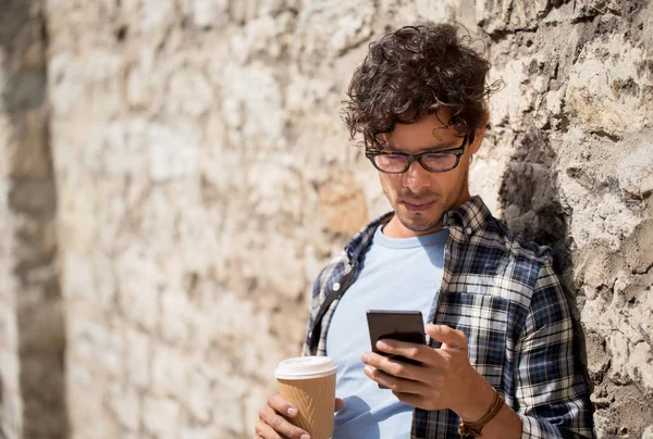 Mann mit Smartphone trinkt Kaffee auf Stadtstraße — Stockfoto