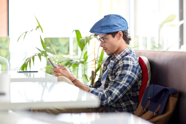 Mann mit Tablet-PC sitzt am Cafétisch — Stockfoto
