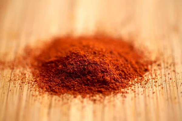 Cayenne pepper or paprika powder on wood — Stock Photo, Image