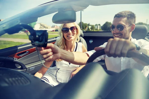 Casal feliz usando o navegador gps em carro cabriolet — Fotografia de Stock