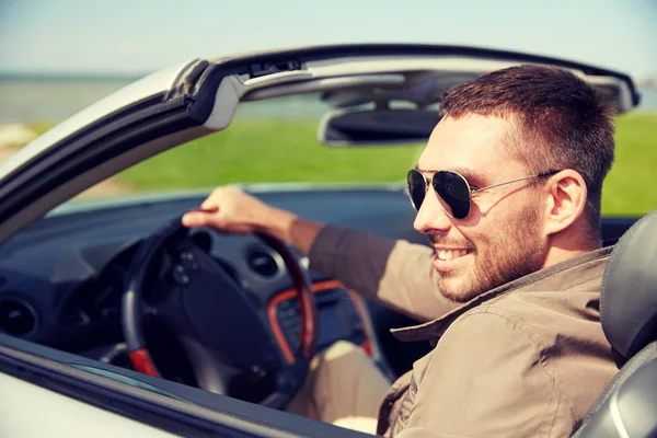 Happy man driving cabriolet car outdoors — Stock Photo, Image