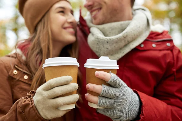 Close up of happy couple with coffee in autumn — Stock Photo, Image