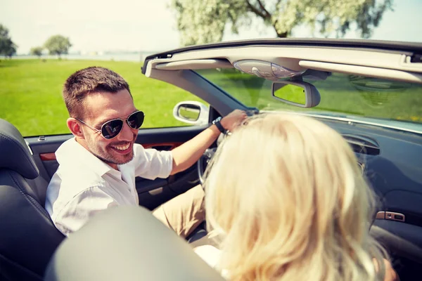 Happy man and woman driving in cabriolet car — Stock Photo, Image