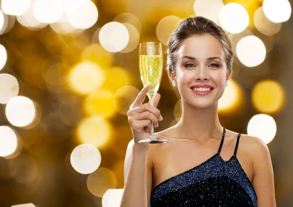 Smiling woman holding glass of champagne — Stock Photo, Image