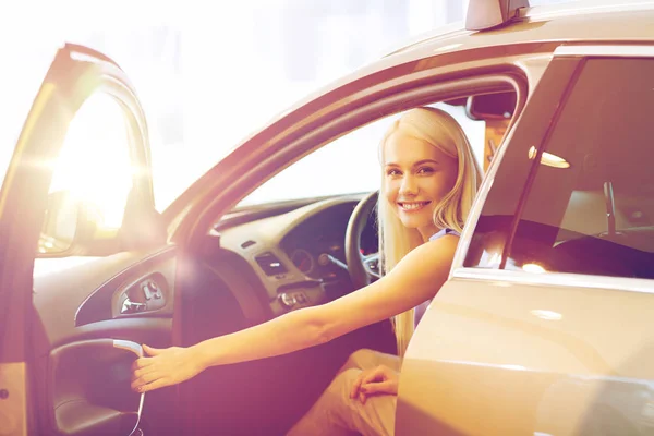 Glückliche Frau im Auto in Autoshow oder Salon — Stockfoto