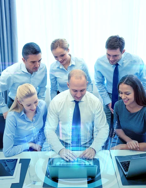 Smiling business people with laptop in office — Stock Photo, Image