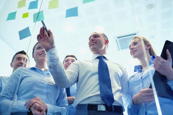 Smiling business people with marker and stickers — Stock Photo, Image