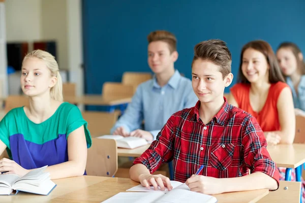 Group of students with notebooks at school lesson — Stock Photo, Image