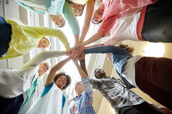 Group of international students with hands on top — Stock Photo, Image