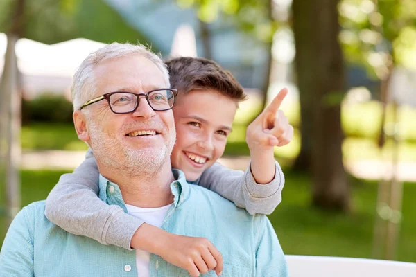 Grandfather and boy pointing finger at summer park — Stock Photo, Image