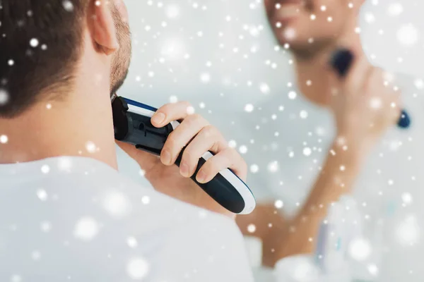 Close up of man shaving beard with trimmer — Stock Photo, Image